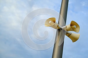 Loudspeakers for outdoor announcements. Blue sky background