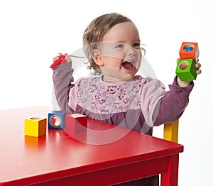 Loughing child with building bricks