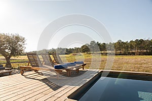 Lounge chairs in modern villa pool