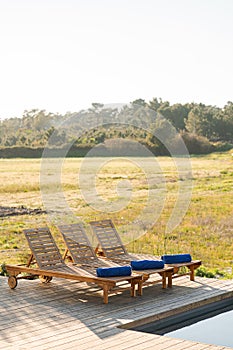 Lounge chairs in modern villa pool
