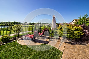 Lounge Chairs Overlooking Green Field & Blue Pond