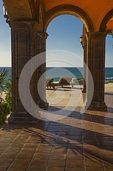 Lounge chairs on a peaceful tropical terrace in Mexico overlooking the Pacific ocean