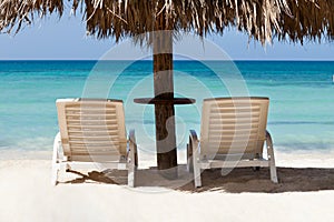 Lounge chairs under sunshade at beach