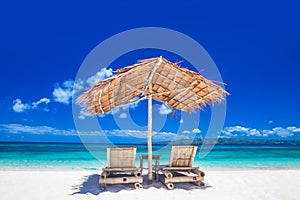 Lounge chairs under tent on beach