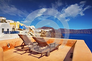 Lounge chairs with a view of the caldera, Oia village, Santorini