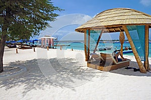 Lounge chairs on white sand beach