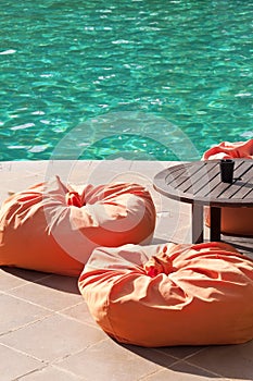 Lounge with pouffes by a pool