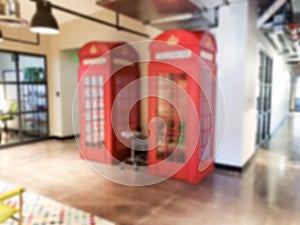 Lounge seating area with phone booths with blurred background