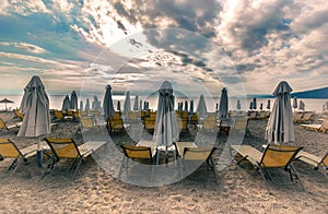 Lounge sun bed and umbrella on tropical beach sunrise morning