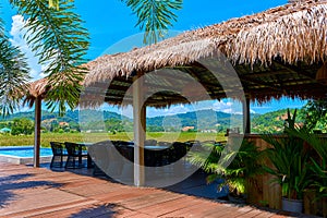 Lounge with a tropical mountain landscape. Terrace with a shelter by the pool overlooking the mountains