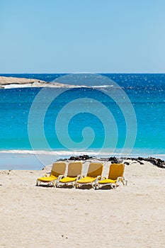 Lounger chairs on sandy beach in Cape Town