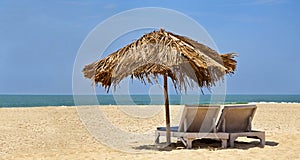 Loungers desserted beach blue sky