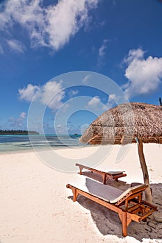 Loungers and parasol on a tropical beach, Isle of Pines