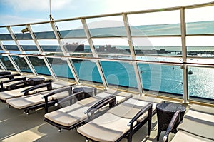 Loungers reclined on sun deck of cruise ship