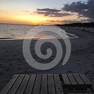 Lounges the beach at Sunset on the Gulf Shore