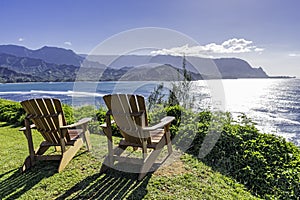 Lounging chairs overlooking Hanalei Bay and the Na Pali coast Princeville Kauai Hawaii USA