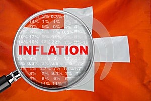 Loupe focused on the word inflation on Switzerland flag background. Inflation, tax, financial concept in Swiss
