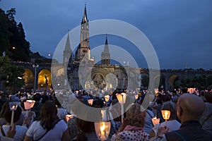 Lourdes, France, 24 June 2019: Evening procession with candles at the shrine of Lourdes