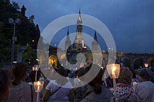 Lourdes, France, 24 June 2019: Evening procession with candles at the shrine of Lourdes