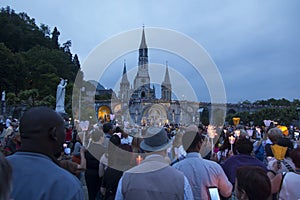 Lourdes, France, 24 June 2019: Evening procession with candles at the shrine of Lourdes