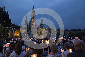 Lourdes, France, 24 June 2019: Evening procession with candles at the shrine of Lourdes