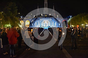 Pilgrims attend the Marian Torchlight Procession service at the Rosary Basilica in Lourdes