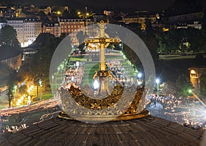 LOURDES, FRANCE - SEPTEMBER 14 2019: Cross in front of the candle procession, every night in Lourdes, France, Europe