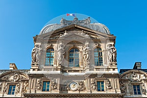 Louvre museum with french flag