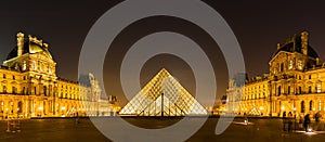 The Louvre Museum lit up at night in Paris, France