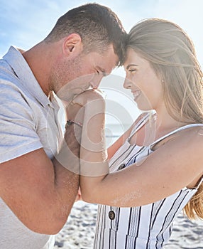 Love, affection and couple with kiss at the beach on a romantic date to relax together in summer. Trust, care and man