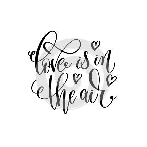 Love is in the air black and white hand lettering inscription