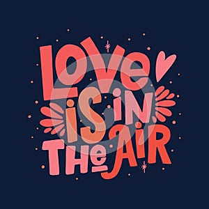 `Love is in the air` lettering isolated on dark blue background. Handwritten poster or greeting card. Valentine`s Day typography.