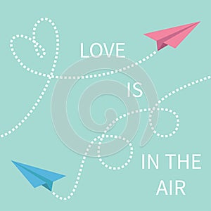 Love is in the air Lettering text. Two flying origami paper plane.