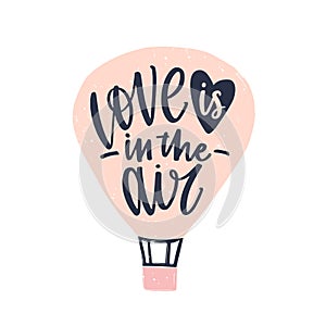 Love Is In The Air phrase handwritten with elegant cursive calligraphic font on air balloon. Modern romantic lettering