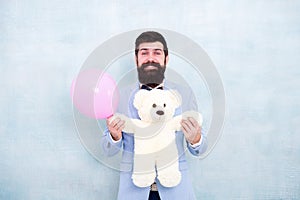 Love is in the air. romantic man in tuxedo bow tie. gift with love. Stereotypical presents. Romantic man with teddy bear photo