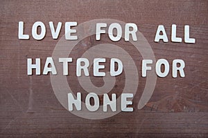 Love for all, hatred for none, peace quote phrase composed with wooden letters