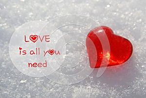 Love is all you need.Valentine`s Day greeting card with decorative red heart on natural white snow background.14th of February.