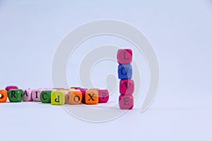 Love alphabet written on colourful stack wooden block with white background