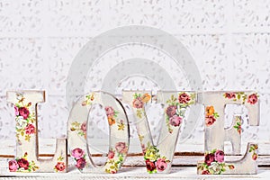 love background with decoupage decorated letters with rose pattern