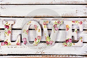 love background with decoupage decorated letters with rose pattern