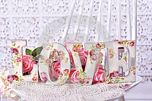 love background with decoupage decorated letters with rose pattern