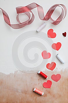 Love Background with paper hearts and red ribbon. Space for text on white background. Valentines day concept. Greetings