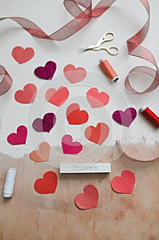 Love Background with paper hearts and red ribbon. Space for text on white background. Valentines day concept. Greetings