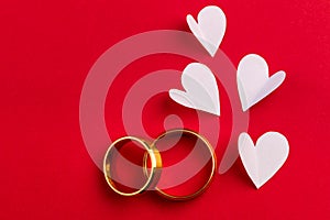 Love background - two gold wedding rings and handmade hearts de