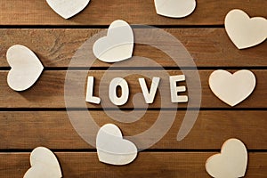 Love background with wooden cutouts on wooden slat table