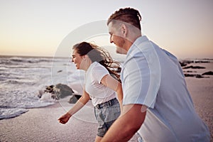 Love, beach and couple holding hands running to the water on a romantic sunset evening together outdoors in nature