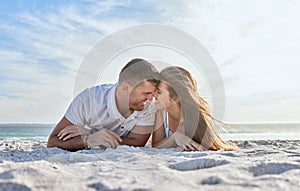 Love, beach and couple laying in sand, happy woman with man on a summer holiday at ocean. Romance, nature and sun, a
