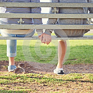 Love is a beautiful thing. Rearview shot of a young gay couple sitting together on a park bench.