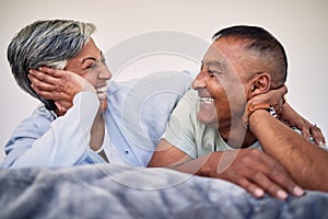 Love, bedroom face and elderly couple laugh, bond and enjoy quality time together, funny conversation and relax. Home