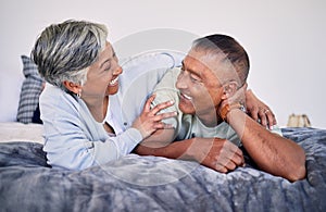 Love, bedroom and laughing senior couple bonding, happy and enjoy quality time together, funny conversation or comedy